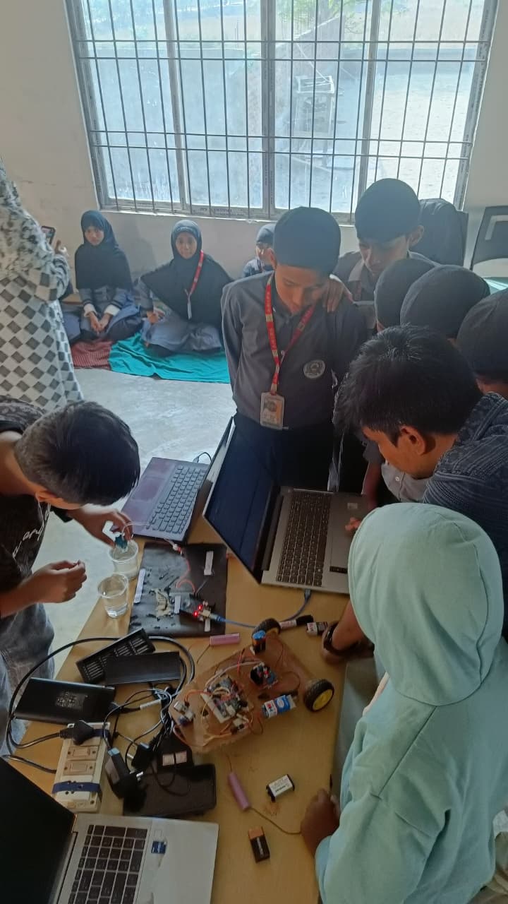 Students working on a water turbidity measurement system with electronics kits